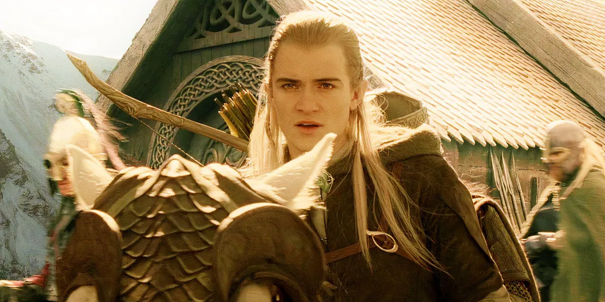 Orlando Bloom as Legolas riding a horse as people around him prepare for battle in The Lord of the Rings: The Return of the King.