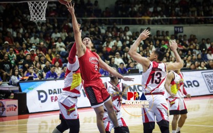 <p><strong>UNDERGOAL.</strong> Scottie Thompson eludes three defenders for an undergoal stab as Ginebra escapes an 102-99 victory against San Miguel Beer in Game 6 at the at the Smart Araneta Coliseum in Quezon City on Sunday night (Oct. 20, 2024). The Gin Kings advanced to the finals against Talk ‘N Text. (Photo courtesy of PBA Image)</p>