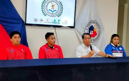 <p><strong>QUALIFIERS.</strong> Samahang Weightlifting ng Pilpinas president Monico Puentevella (2nd from right) joins Paris Olympics qualifiers Elreen Ann Ando, John Febuar Ceniza and Vanessa Sarno (from left) during the Philippine Sportswriters Association (PSA) Forum at the Rizal Memorial Sports Complex on May 7, 2024. The three athletes will grace the Philippine Open in Cebu. <em>(PNA photo by Jean Malanum) </em></p>