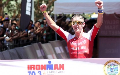 <p><strong>CHAMPION.</strong> South African Henri Schoeman, bronze medalist at the 2016 Rio Olympics, celebrates his victory in the IRONMAN 70.3 Lapu-Lapu in Cebu on April 21, 2024. The blue-ribbon event, which is expected to attract a dynamic mix of local and international triathletes, will be held on August 10, 2025. <em>(Contributed photo) </em></p>
