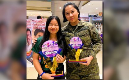 <p><strong>CHAMP. </strong>Champion Ruelle Canino (left) poses with Woman Grandmaster Janelle Mae Frayna, who finished third, during the awarding ceremony of the Philippine National Women’s Chess Championship in Malolos, Bulacan on March 24, 2024. Canino will lead the Far Eastern University team in the Bangkok Open scheduled April 13-21 in Thailand. <em>(Contributed photo) </em></p>