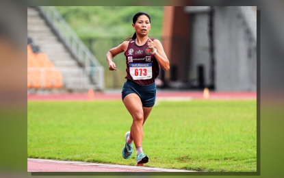 <p><strong>DOUBLE-GOLD MEDALIST.</strong> University of the Philippines runner Mea Gey Niñura competes in the women's 5,000 meters event in the UAAP Season 87 athletics tournament at the New Clark City Stadium in Capas, Tarlac on Monday (Nov. 18, 2024). She won the race to claim her second gold medal after ruling the 10,000 meters last Sunday. <em>(UAAP photo) </em></p>