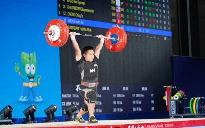 <p><strong>SILVER MEDALIST.</strong> Elreen Ando competes in the Asian Weightlifting Championships women's 64kg category at the Husnan Sports Park in Zhejiang, China on Sunday (May 11, 2025). She finished second behind Chinese Li Shuang while Korean Mun Minhee was third. <em>(Photo courtesy of Asian Weightlifting Federation) </em></p>
