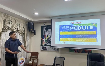 <p><strong>GOING FOR THE WIN. </strong>Department of Education-Bicol Regional Director Gilbert Sadsad shows the schedule of activities for the 2024 Palarong Pambansa during a press conference at DepEd-5 regional office in Legazpi City on Thursday (July 4, 2024). More than 700 delegates from the Bicol Region will join the competition in Cebu City from July 9 to 16, 2024. <em>(PNA photo by Connie Calipay)</em></p>